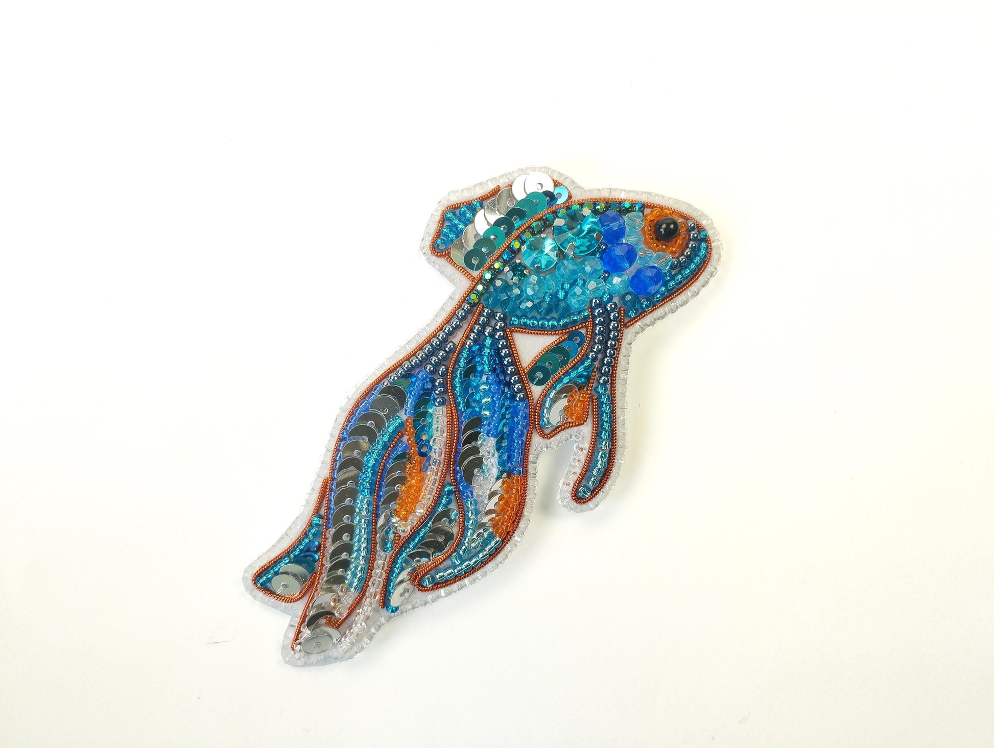 a brooch with a fish design on it
