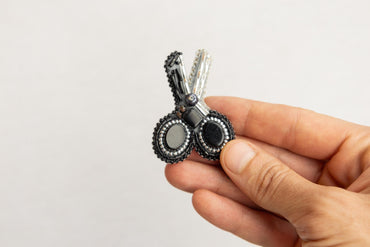 a person is holding a tiny black and white object