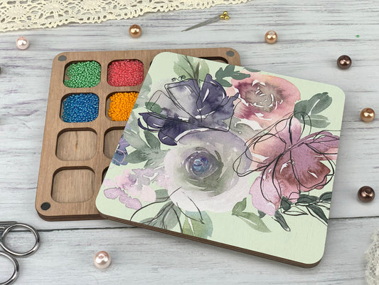 a wooden tray with a flower painted on it