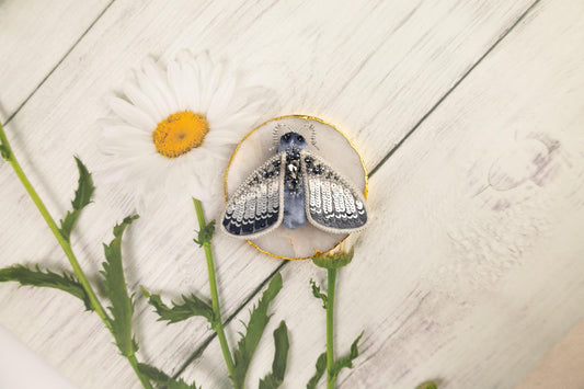 a pair of blue shoes sitting on top of a flower