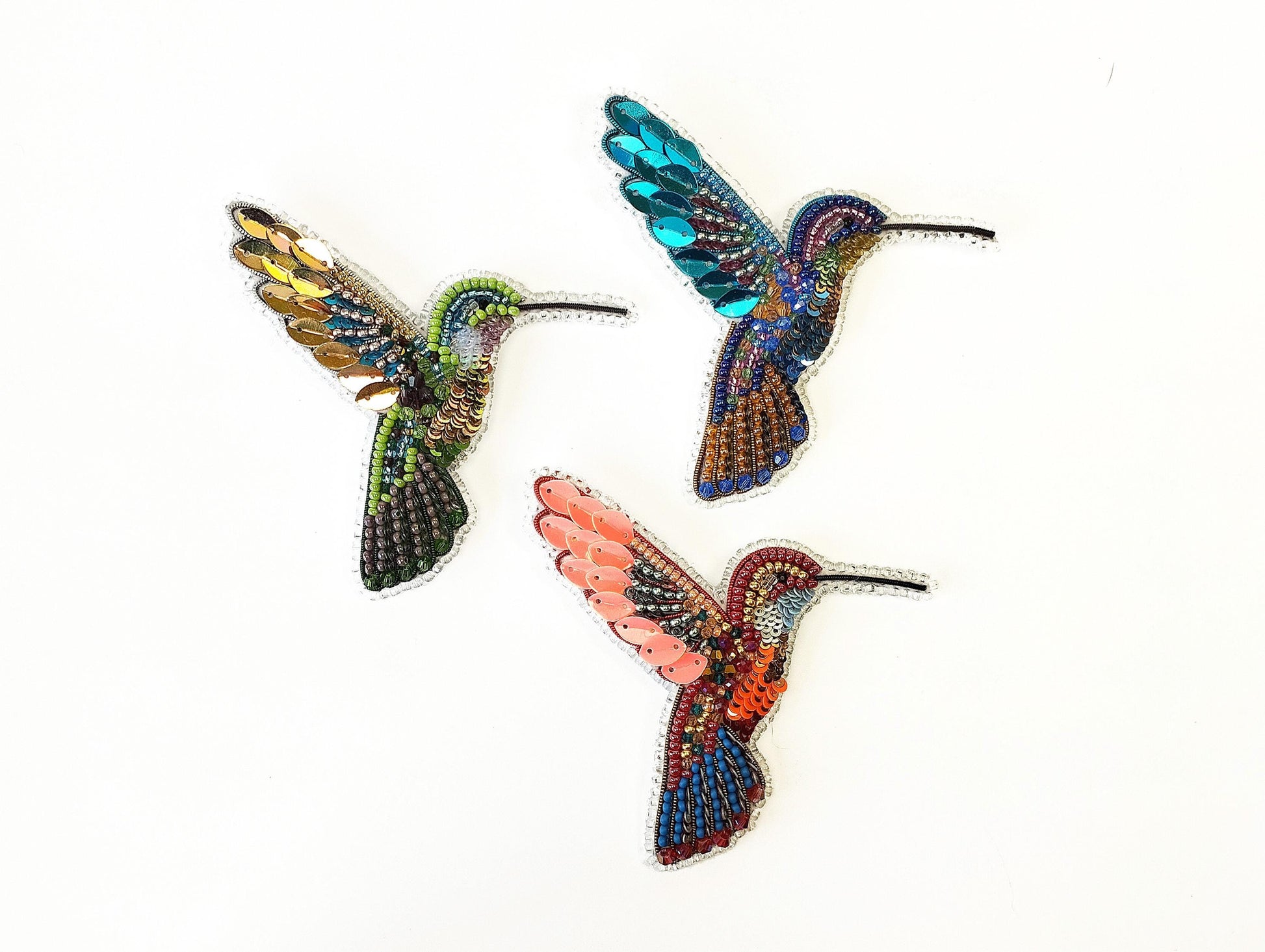 a group of three colorful birds flying next to each other