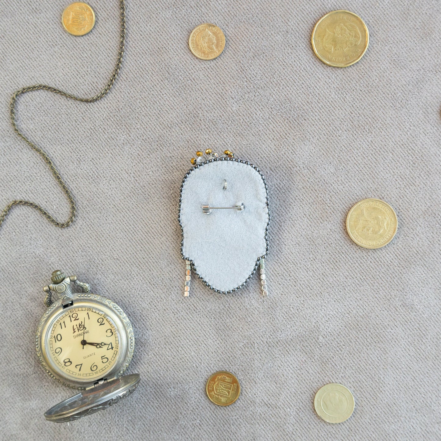 a clock and some coins on a table