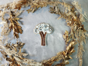 a brooch with a tree in the middle of it