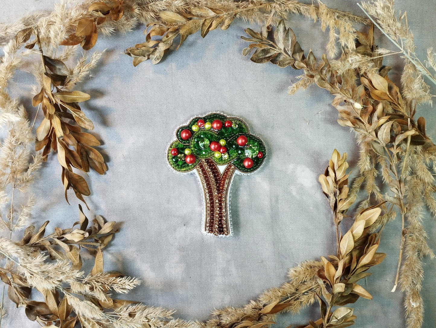 a brooch with a tree on top of it