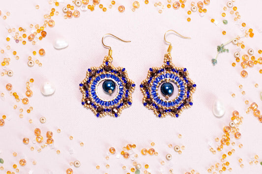a pair of blue and gold beaded earrings