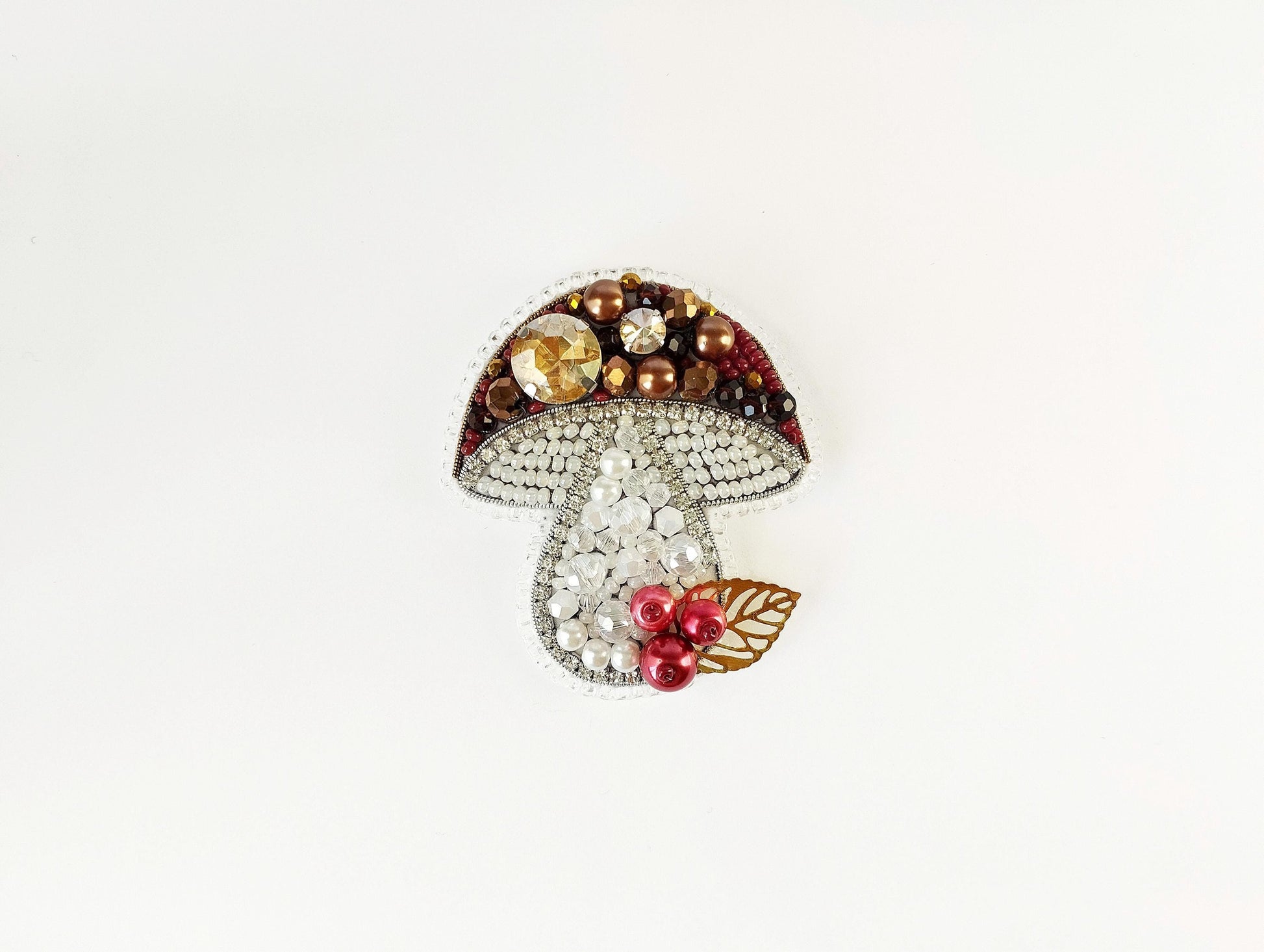 a brooch with a mushroom on top of it
