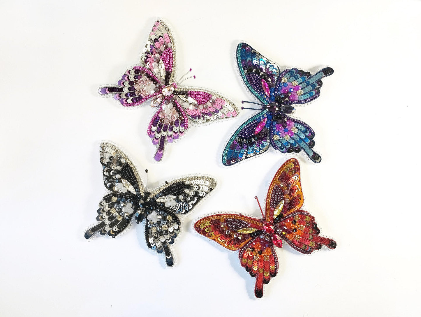 a group of four colorful butterflies sitting on top of a table