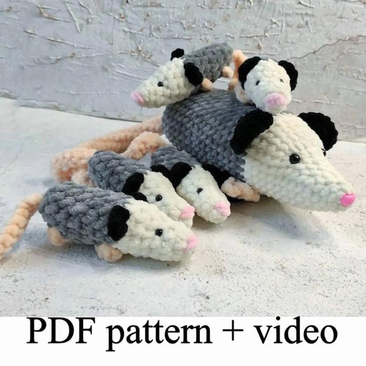 A group of crocheted opossum toys, including a mother opossum and her three offspring, arranged on a white surface.