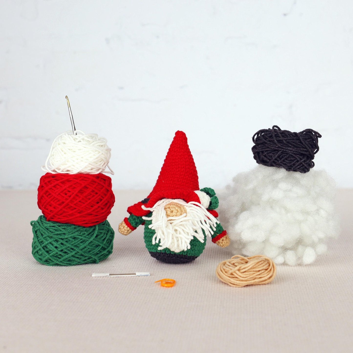 a couple of knitted gnomes sitting next to each other