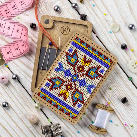 a cross stitch pattern on a piece of wood