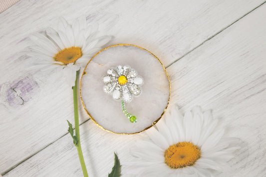 a white flower sitting on top of a wooden table