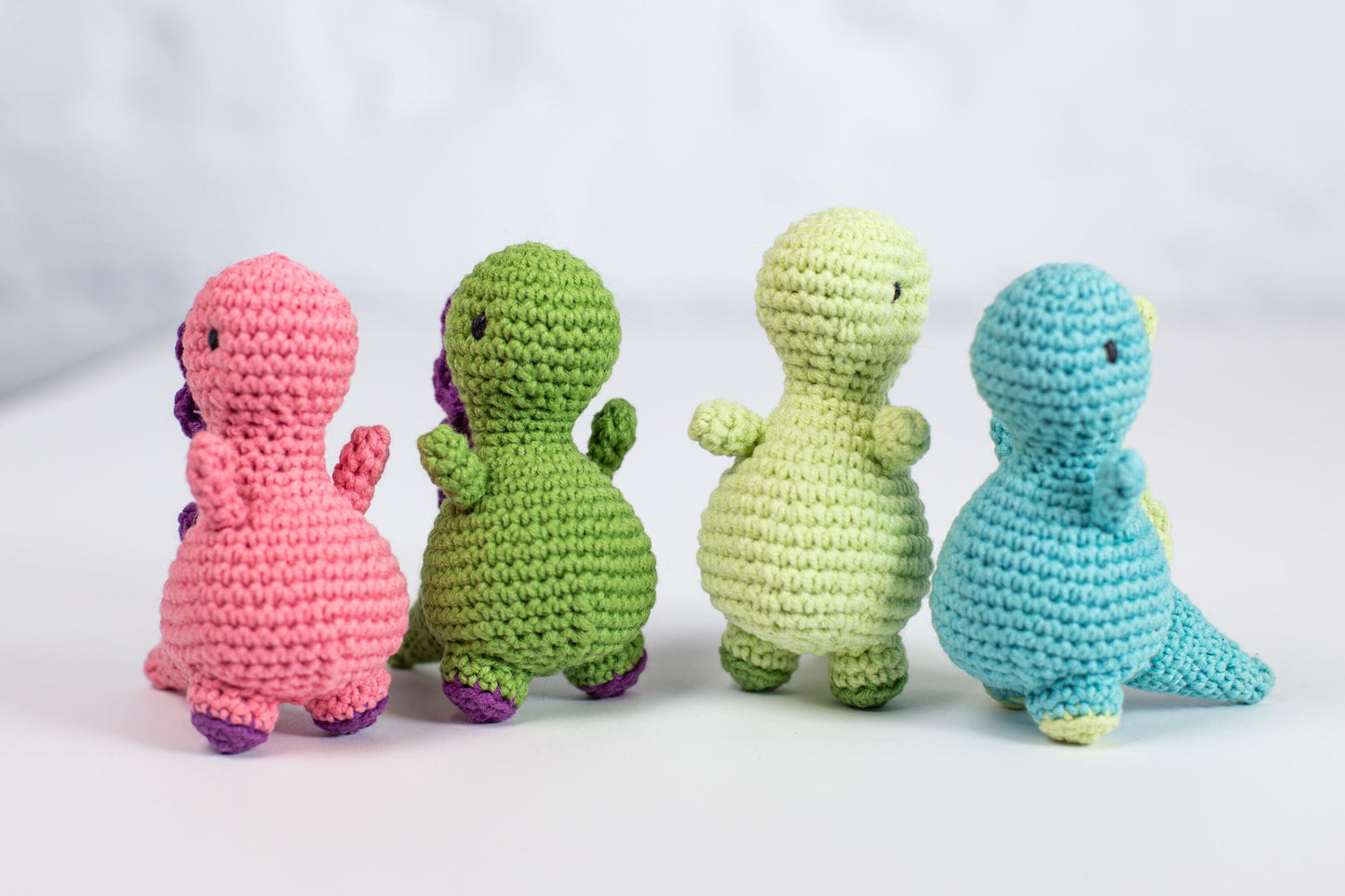 a group of crocheted toy animals sitting next to each other