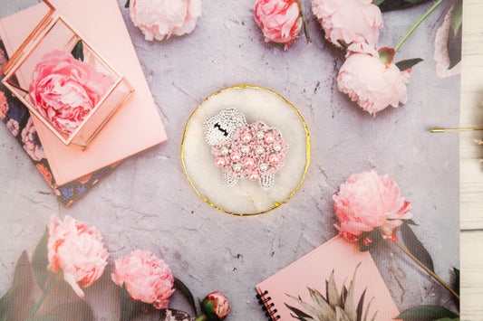 a table topped with pink flowers and a cake