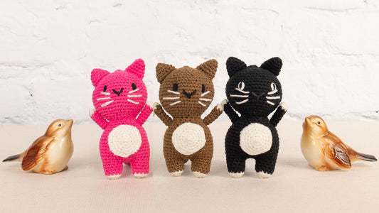 a group of small crocheted animals standing next to each other