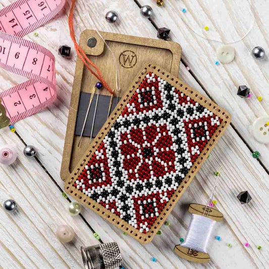 a piece of wood with a needle and thread on it