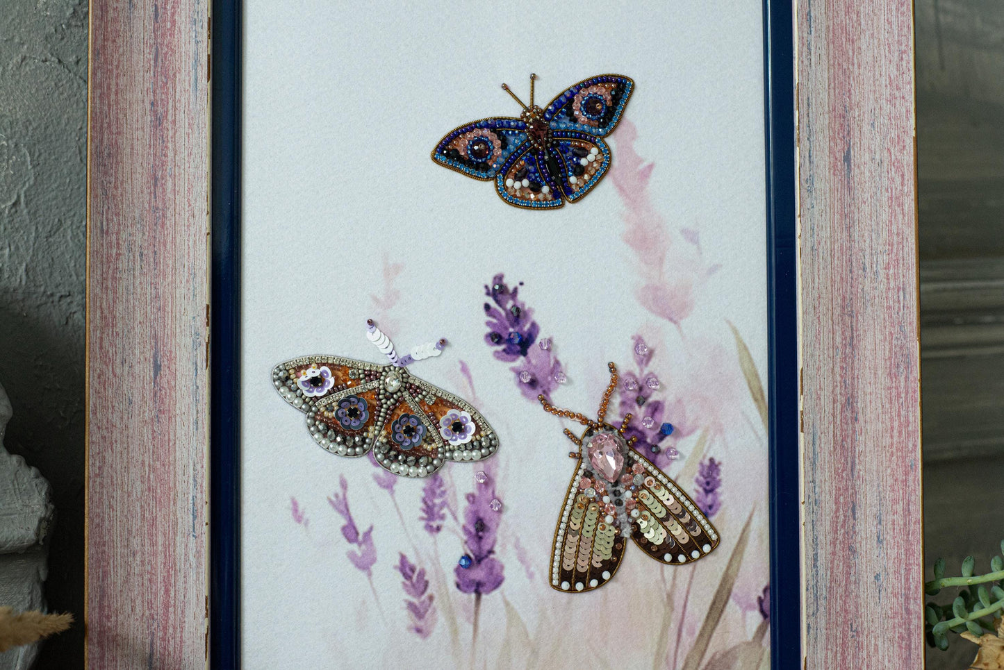 a picture frame with two butterflies and lavender flowers