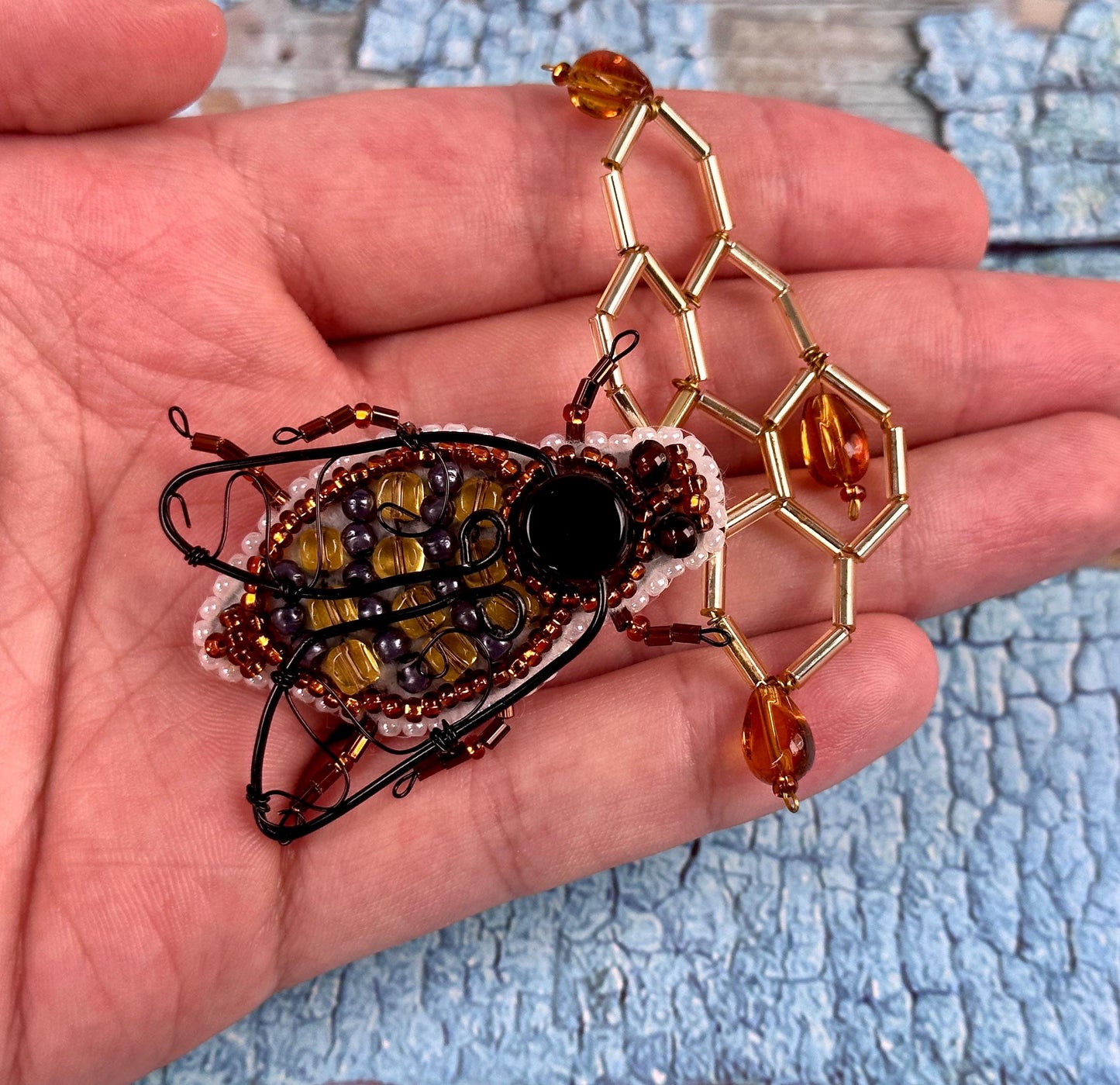 a hand holding a piece of jewelry in it's palm