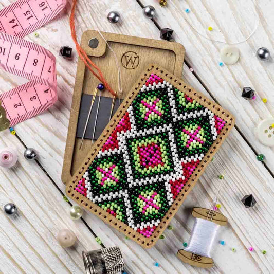 a cross stitch ornament next to a pair of scissors