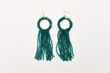 a pair of green beaded earrings on a white background
