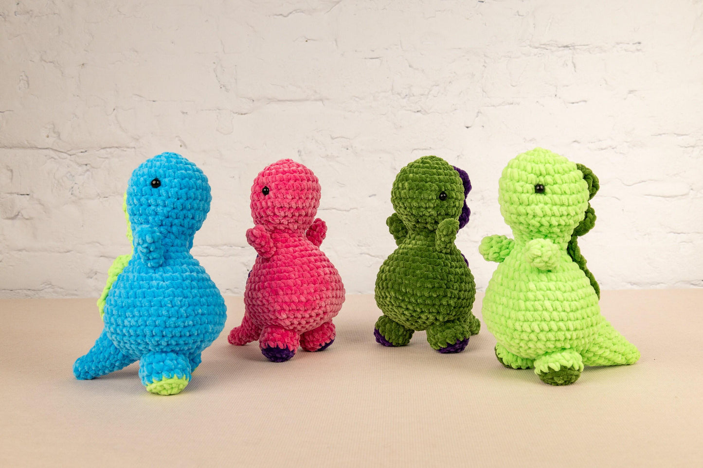 a group of crocheted stuffed animals sitting next to each other