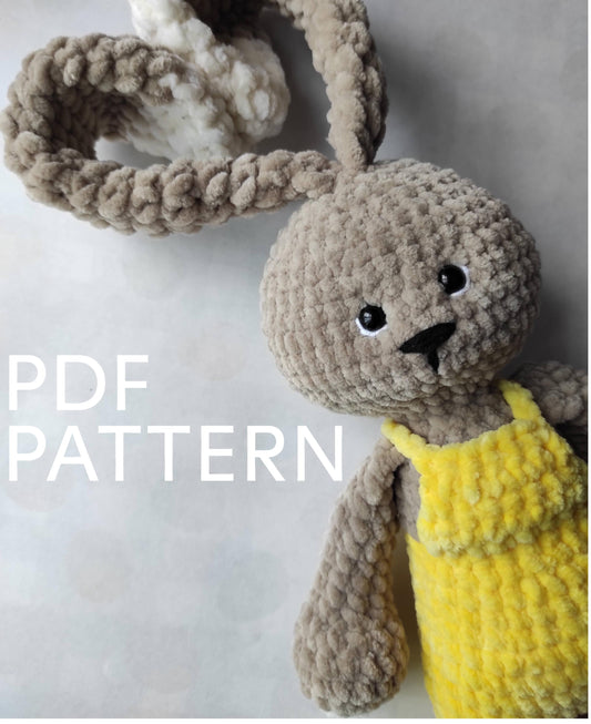 a crocheted bunny with a yellow dress