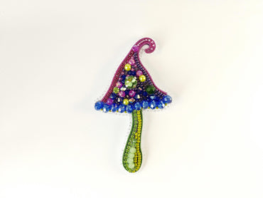 a beaded decoration of a mushroom on a white background