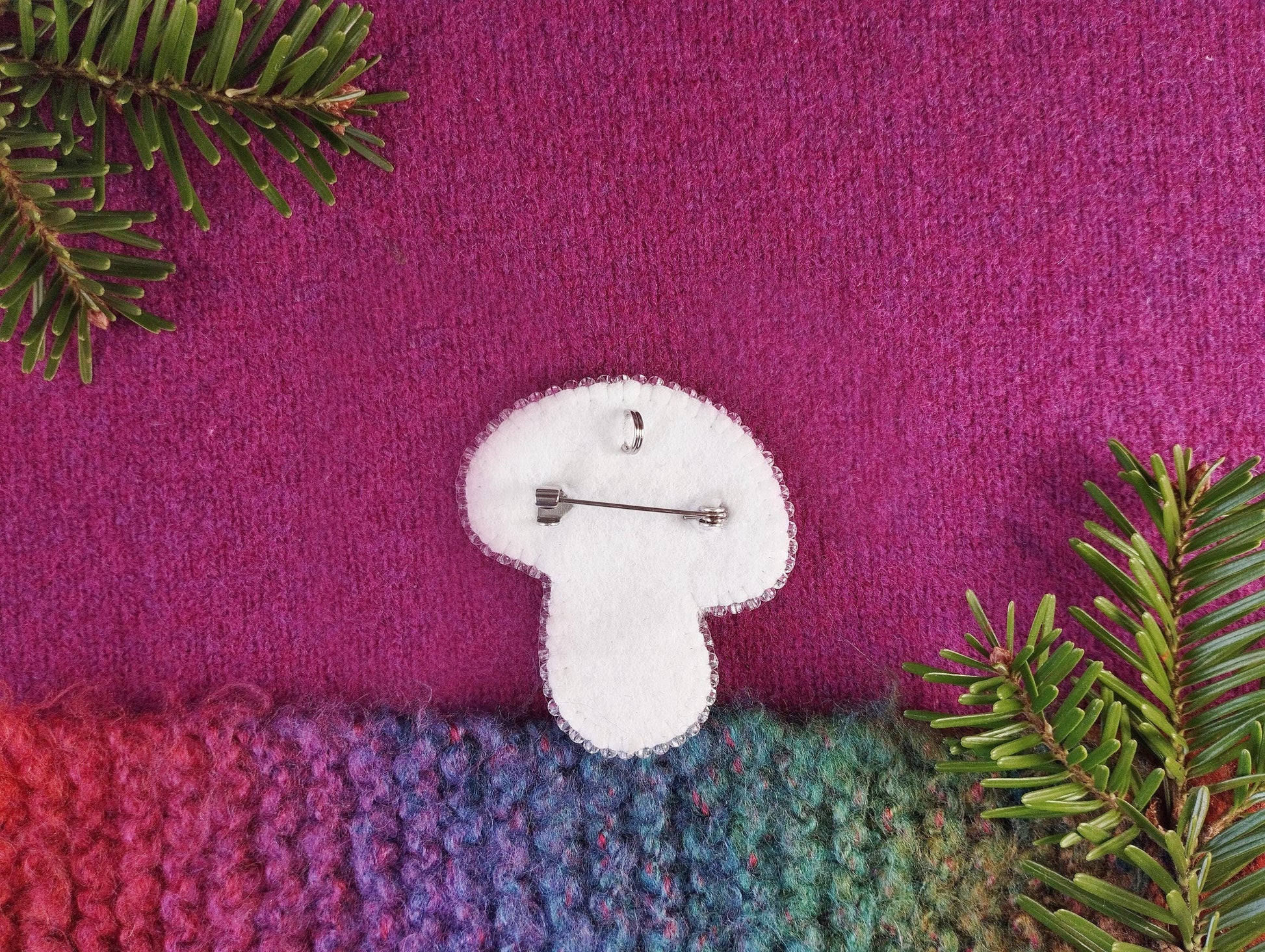 a knitted piece of cloth with a pin on it
