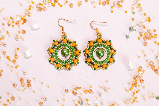 a pair of green and yellow beaded earrings