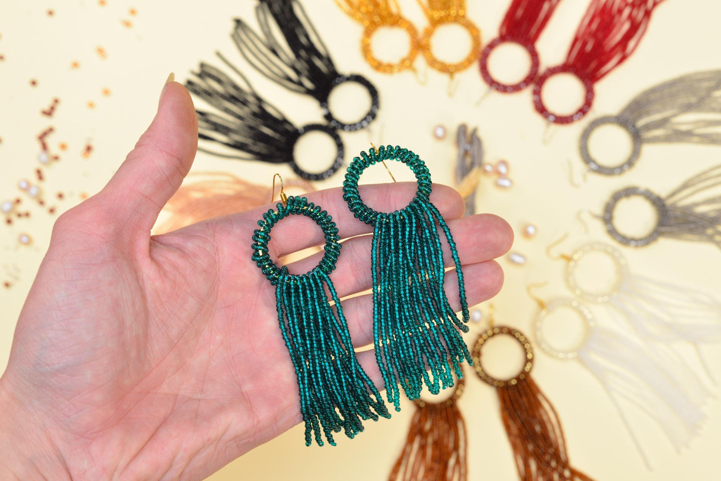 a person holding a pair of earrings in their hand