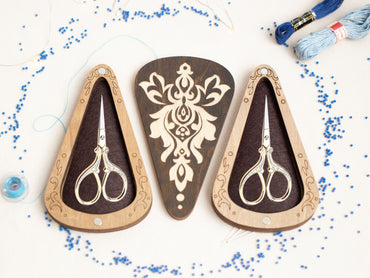 a pair of scissors sitting on top of a table