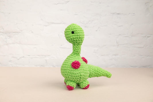 a green crocheted toy sitting on top of a table