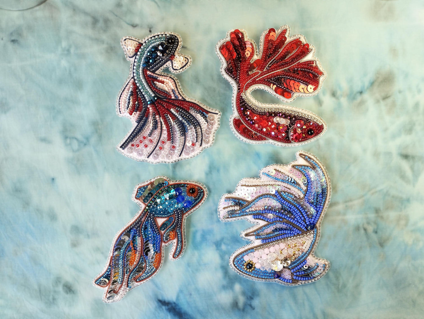 a group of three different colored fish on a blue background