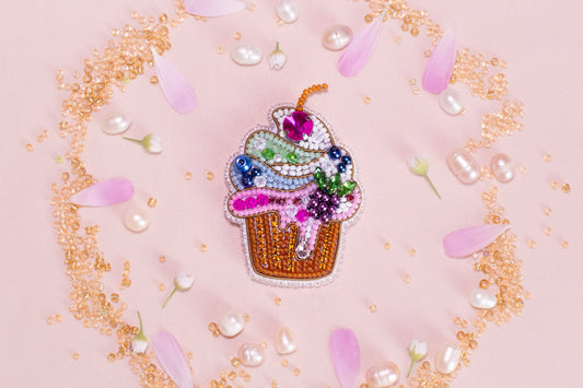 a pin with a cupcake on top of it
