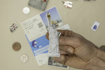 a person holding a piece of jewelry in their hand