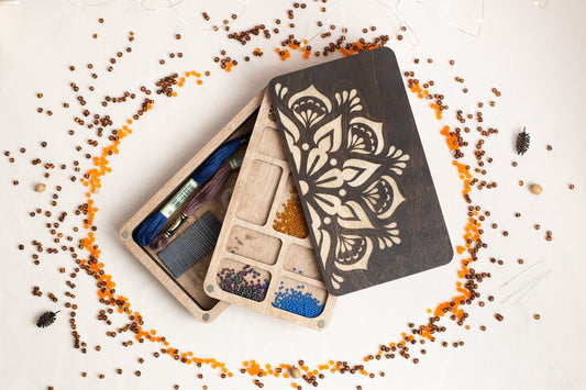 a couple of wooden boxes filled with crafting supplies