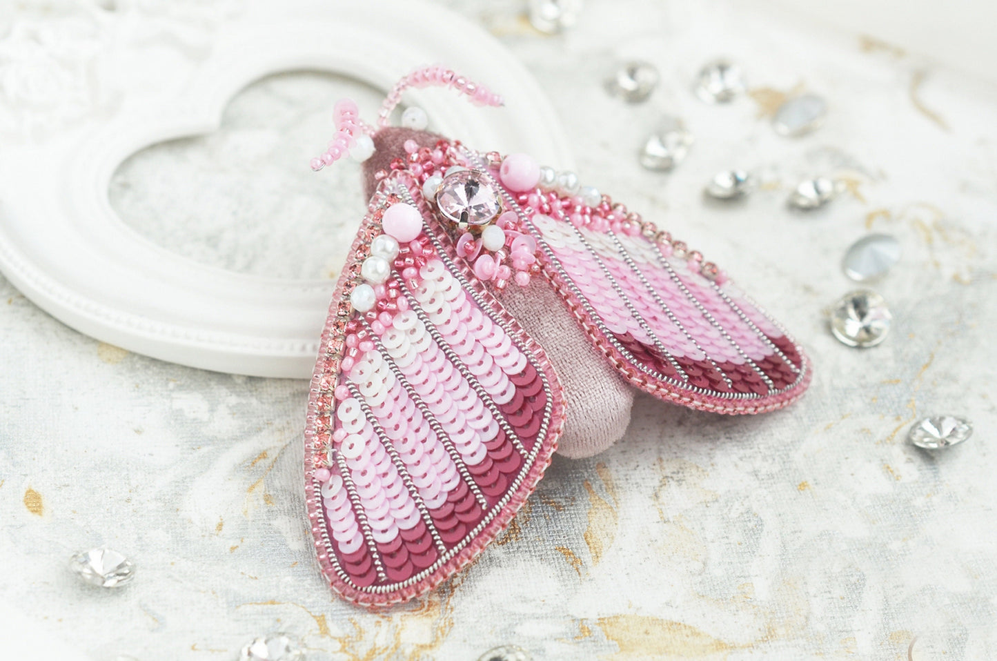 a close up of a brooch with beads on it