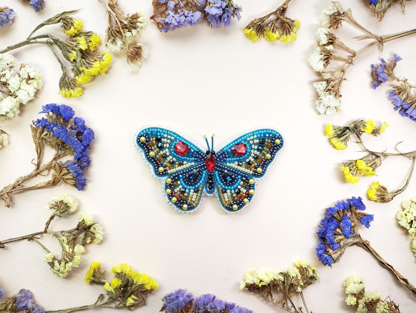a blue butterfly sitting on top of purple and yellow flowers