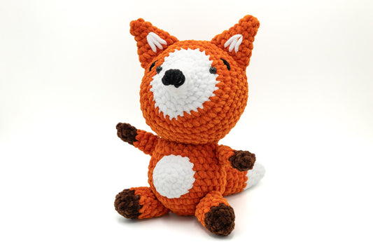 a crocheted orange and white stuffed animal