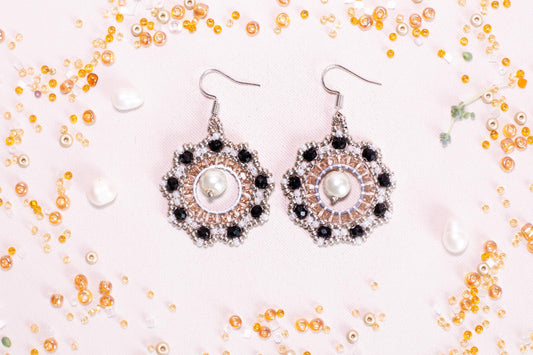 a pair of earrings sitting on top of a table