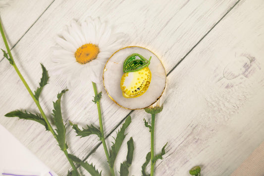 a flower and a piece of fruit on a table