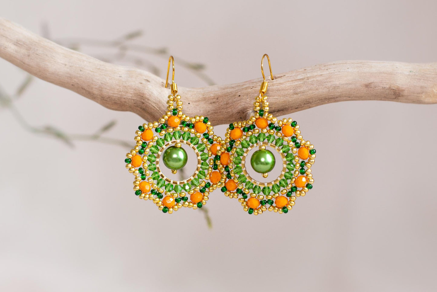 a pair of green and orange beaded earrings