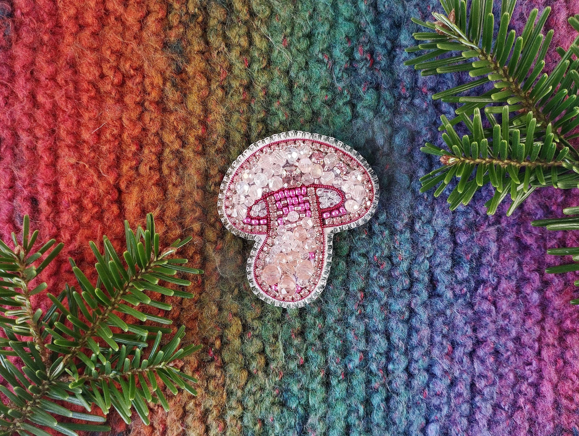 a colorful knitted blanket with a pair of flip flops on top of it