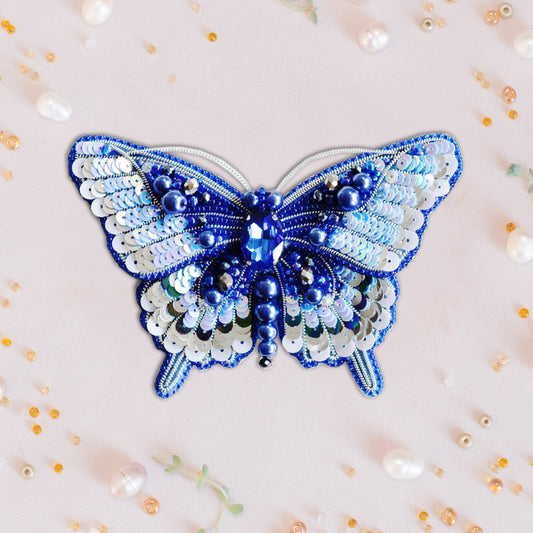 a blue and white butterfly made out of beads