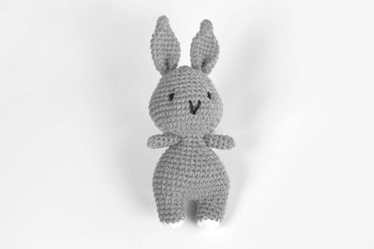 a crocheted stuffed animal sitting on top of a white surface