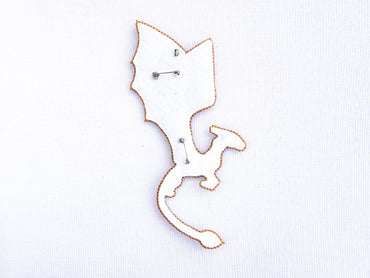 a close up of a metal object on a white surface