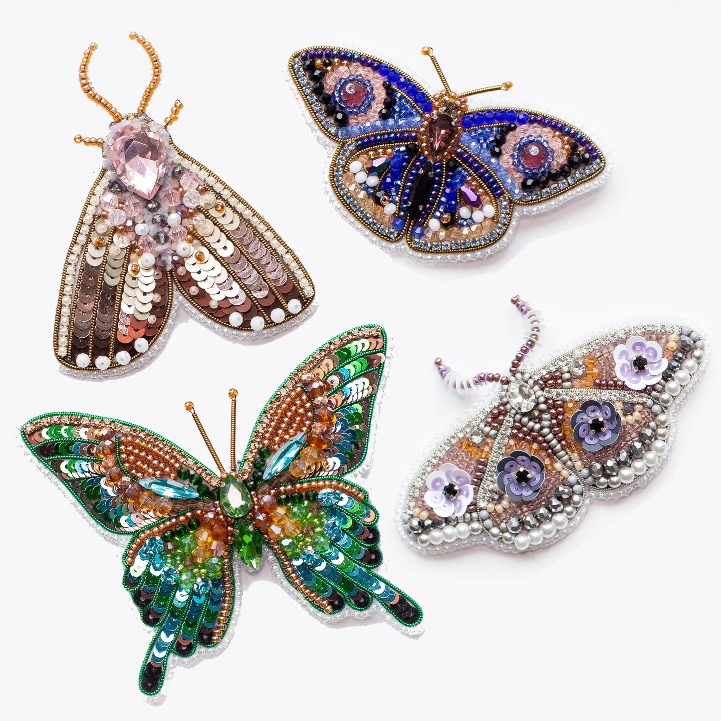 a person holding a butterfly brooch in their hand