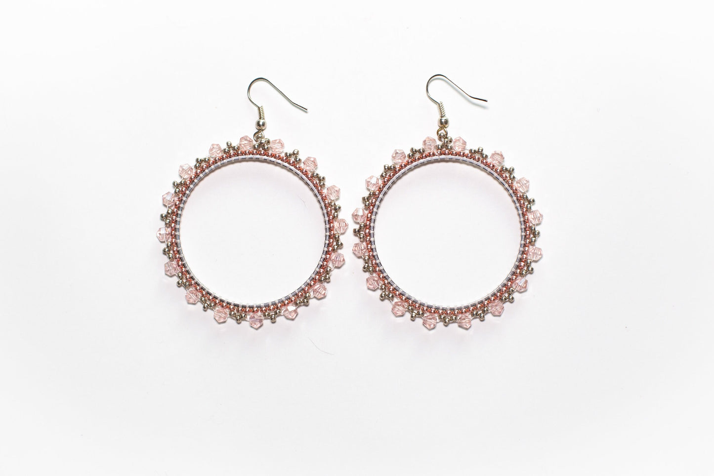 a pair of pink beaded earrings on a white background