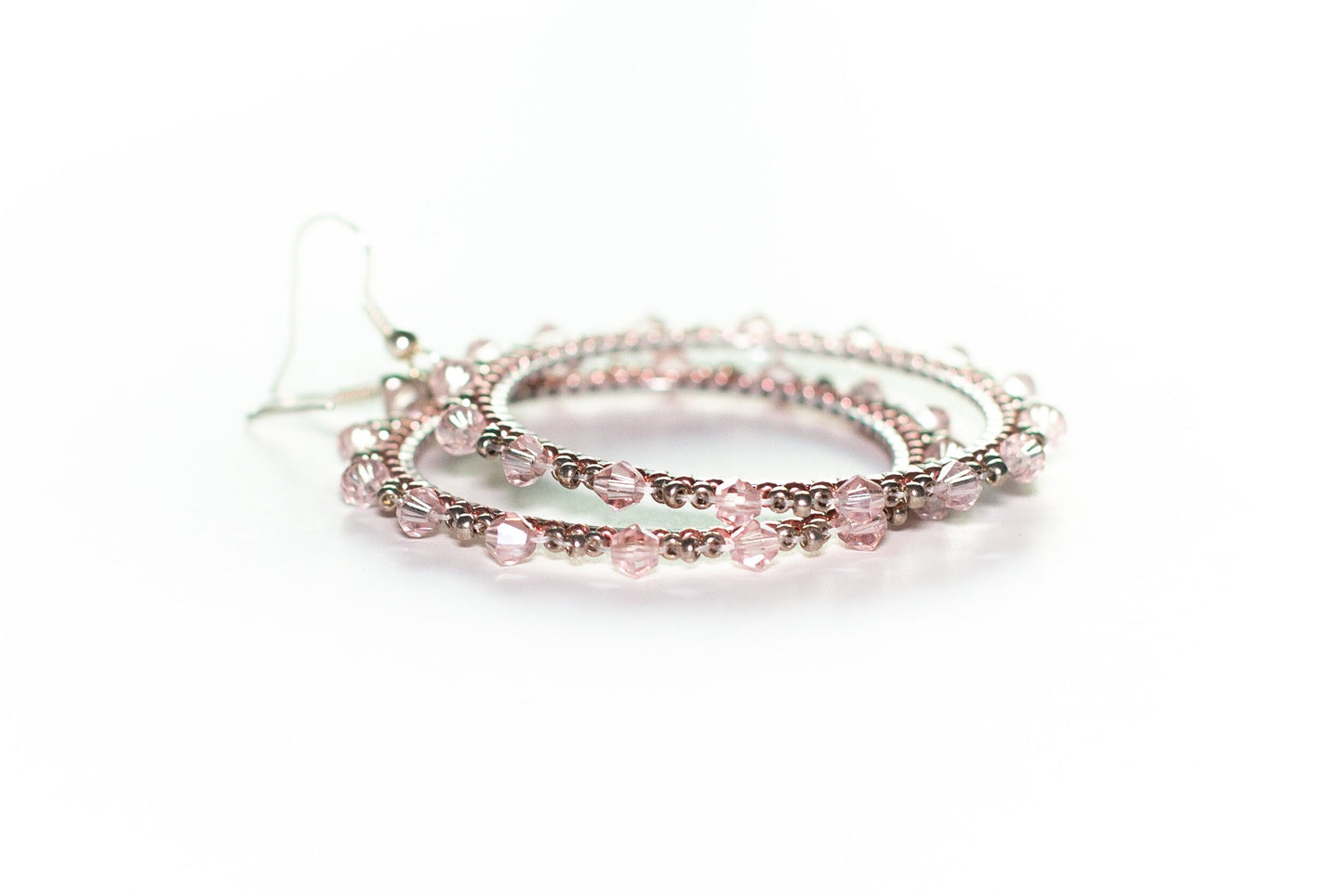 a pair of pink beaded bracelets on a white background