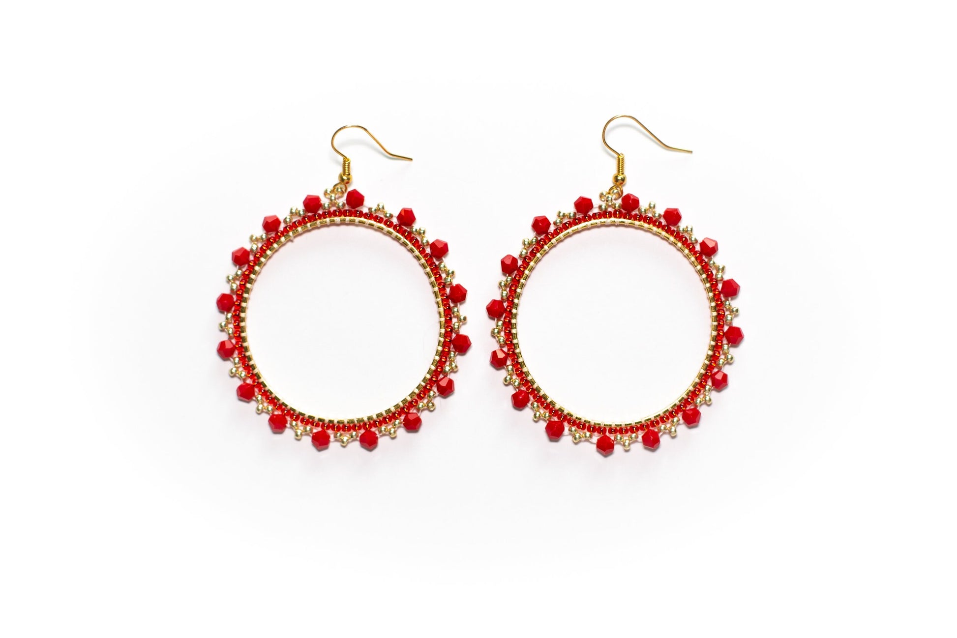 a pair of red beaded hoop earrings