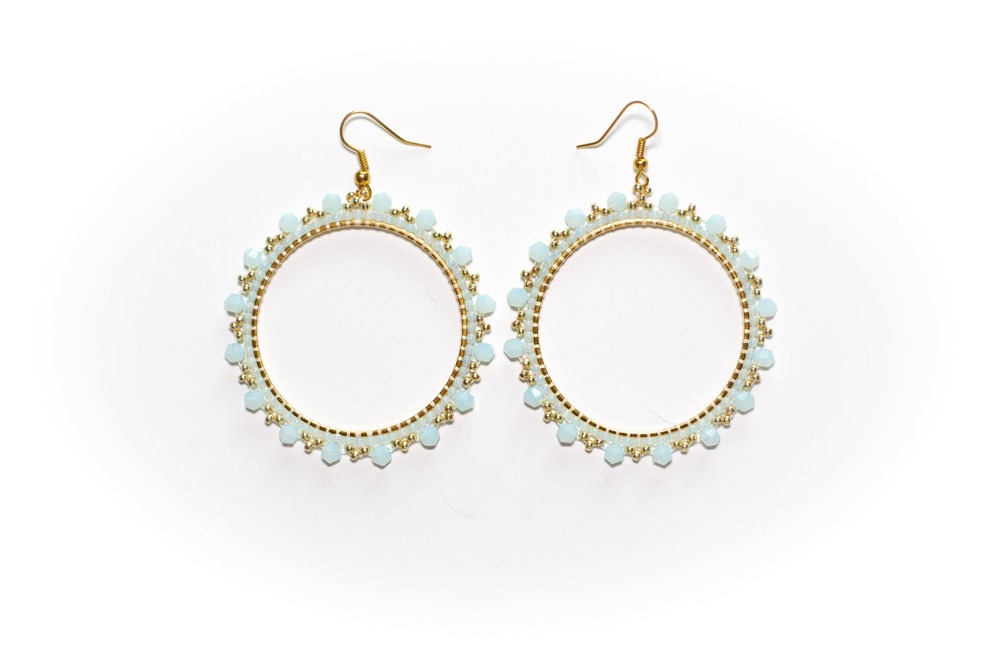 a pair of earrings on a white background